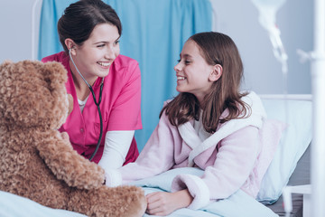 Smiling nurse and young patient