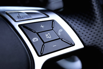 Hands free and media control buttons on the steering wheel in a modern car