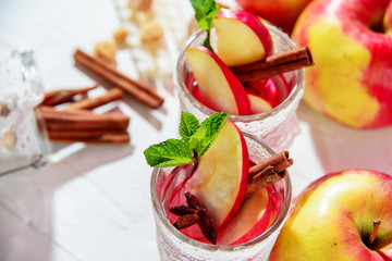mulled wine in fishnet glasses on a light background, Apple, cinnamon, wine