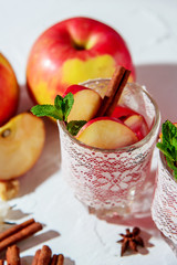 mulled wine in fishnet glasses on a light background, Apple, cinnamon, wine