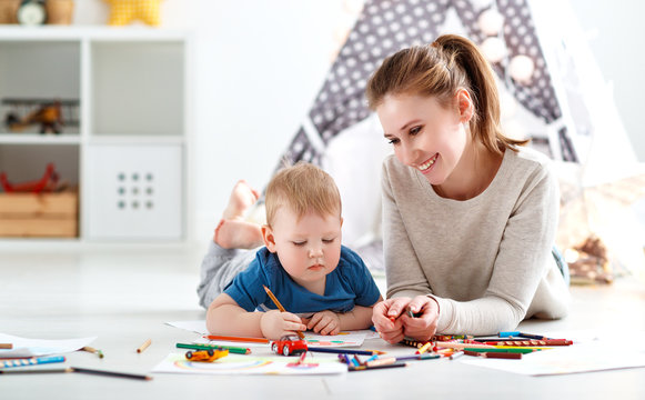 children creativity. mother and baby son drawing together