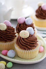 Easter vanilla cupcakes with chocolate frosting