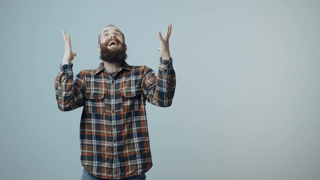 Hipster bearded man jumping into frame full of joy celebrating success emotionally