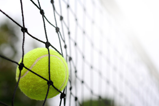 Close up Tennis ball hitting to net