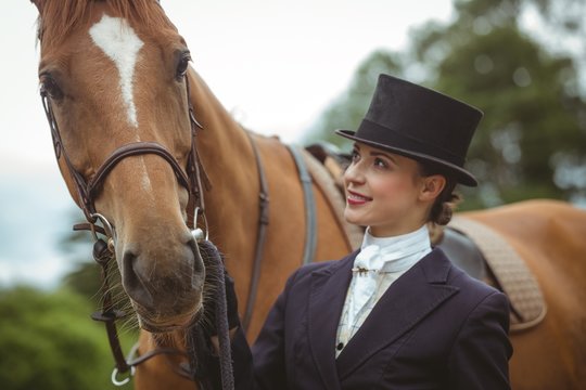 Female jockey leading her horse 