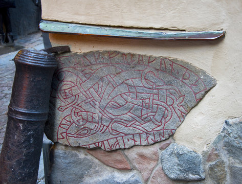 Old runestone built in a wall in old town of Stockholm