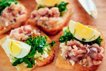 bruschetta with tuna and spinach on toast of white bread, with egg