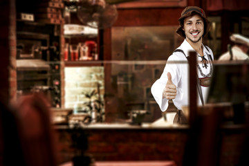 young slim man in bavarian clothes and his own small business of bar 