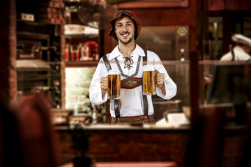 young slim man in bavarian clothes and his own small business of bar 