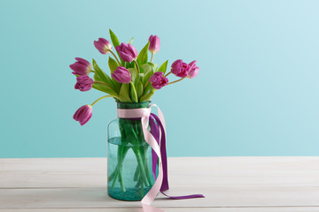 Flowers background, violet tulips at garden background, copy space