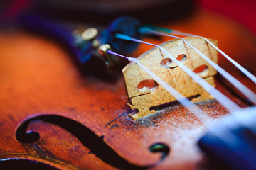 Violin in vintage style with shallow depth of field and selective focus on bridge