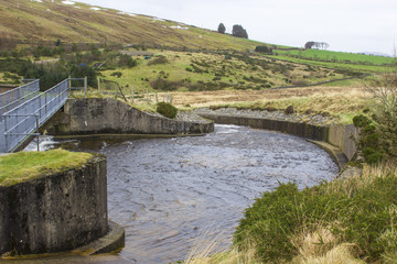 Fototapeta na wymiar The water course at the Fofanny Water treatment centre in Western Mourne Mountains in County Down in Northern Ireland on a dull midwinter day