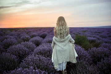 Rolgordijnen Young woman in white dress on the lavender field © Iulia