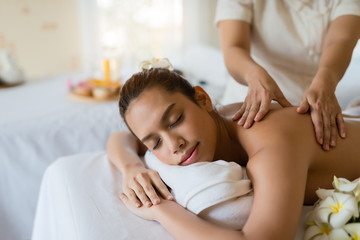 Fototapeta na wymiar Young beautiful Asian woman relaxing in the spa massage