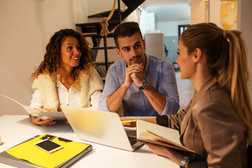 Female Real Estate agent offer home ownership and life insurance to young couple.