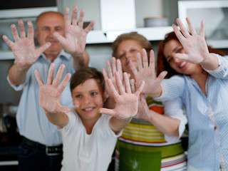 Grandparents, parents and children baking in the kitchen