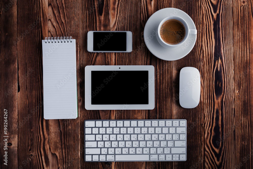 Poster notepad and computer keypad isolated on the wooden desktop