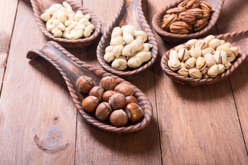 Mix of nuts in wooden spoon