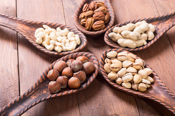 Mix of nuts in wooden spoon