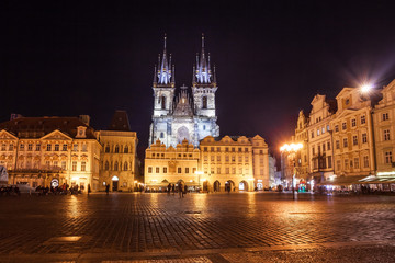 Fototapeta na wymiar Night time illuminations of the magical Old Town Square in Prague, visible are Kinsky Palace and gothic towers of the Church