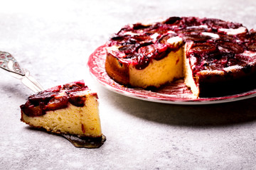 Plum Pie on a light background. Homemade Sweet Dessert. Bake on the Blue Background.