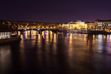 Obraz premium The night View on the Prague National Theater above the River Vltava, Czech Republic