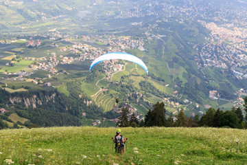 Paragliders start Paragliding in front of Merano panaroma in South Tyrol