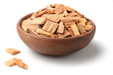 pieces of sandalwood in the wooden bowl, isolated on white