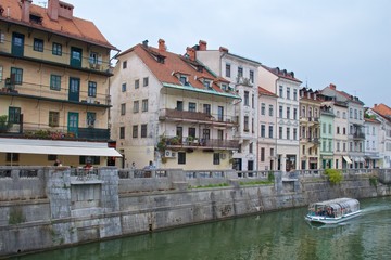Fototapeta na wymiar Old buildings along the bank of Ljubljana River in old Ljubljana in Slovenia