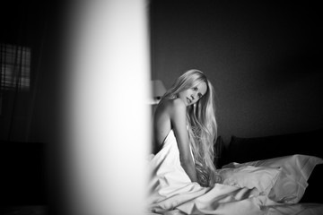 blonde girl lies in bed in the morning
