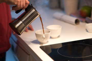 Fototapeta na wymiar Wake up: pouring coffee from a moka pot