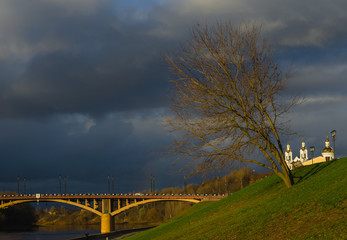 Sunny autumn evening in a small town with a dramatic sky and a Church in the background