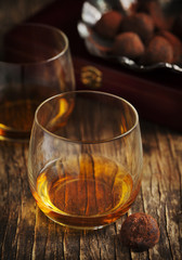 Glass of cognac and chocolate truffles