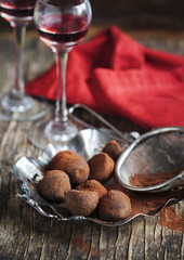 Dark chocolate truffles and two glasses of raspberry  liqueur
