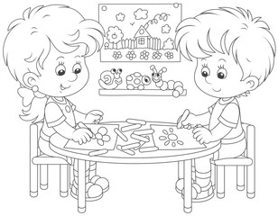 Little children drawing funny pictures with crayons, a black and white vector illustration in cartoon style for a coloring book