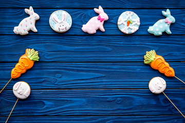 Easter bunny and easter eggs cookies. Easter symbols and traditions. Blue wooden background top view copy space