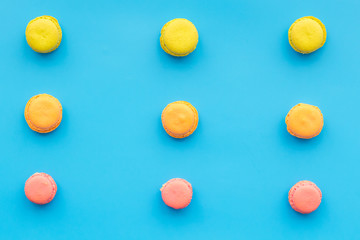 Macarons dessert. Pattern on blue pastel background top view