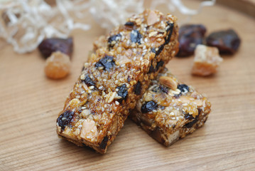 Obraz na płótnie Canvas Energy fitness Muesli Bars with Cereals and nuts. Fit Food concept. Wooden board.