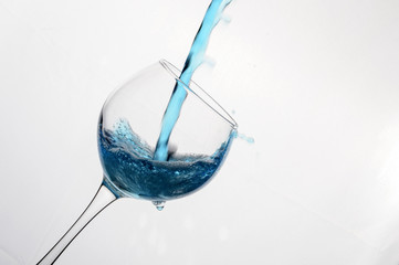 pouring blue wine into a glass