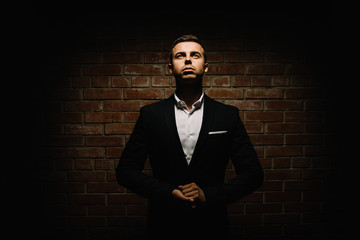Fototapeta premium Handsome young brunette model, wearing in black and white suit, 