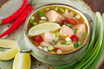 Bowls with salmon soup and veggies