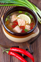 Fresh fish soup with ingredients and spices for cooking. Wooden background. 