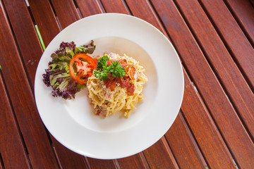 Spaghetti with bacon white cream sauce.