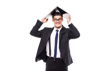 Handsome businessman which holds a laptop above his head in formals standing isolated over white background