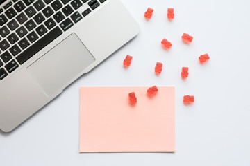 Desk Design Template with Laptop, Blank Note, Pink Candy Gummy Bears