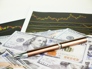 Pen with business graphs and report information background for financial and economy concepts