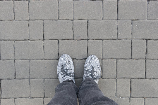 Man legs on gray brick blocks