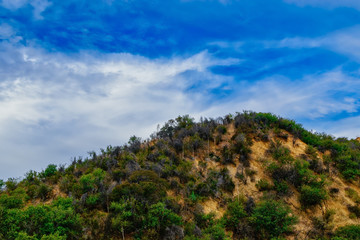 Fototapeta na wymiar Hike along the hilltop to blue sky