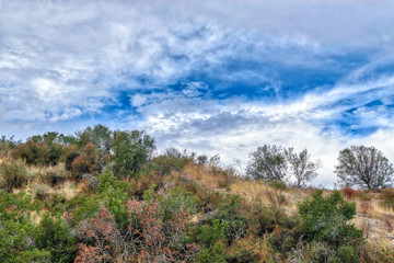 Fototapeta na wymiar Beautiful clouds on hike to top of hillside