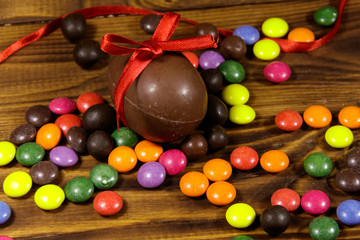 Easter composition with chocolate eggs on wooden background